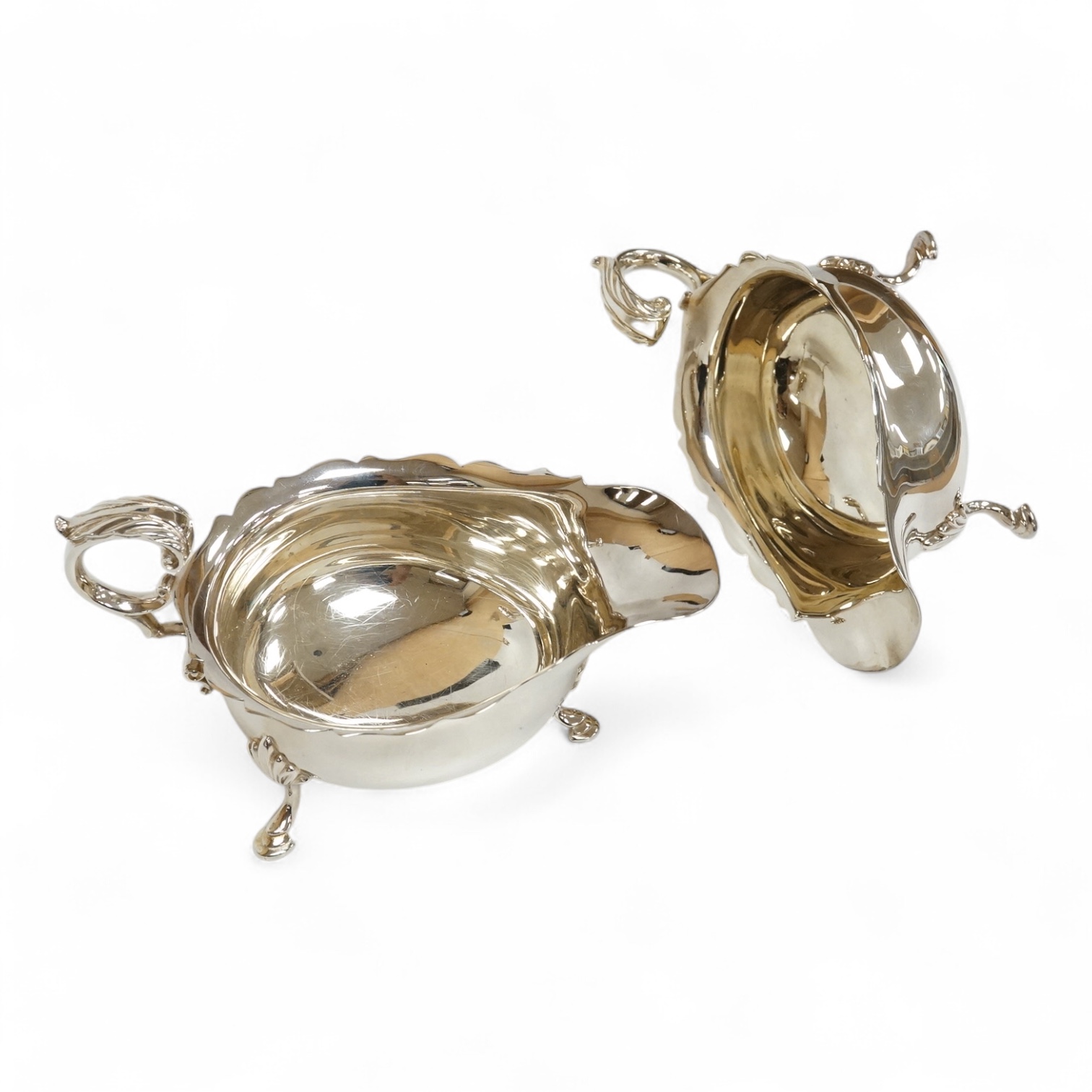 A pair of modern silver sauceboats, with flying scroll handles, C.J. Vander Ltd, Sheffield, 1989, length 14.9cm, 9.5oz.